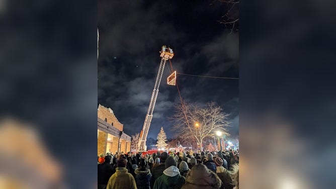 A wedge of cheese on a crane.