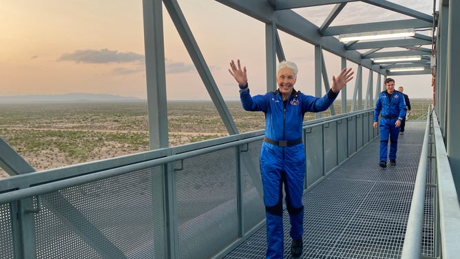 Wally Funk walks across the crew access gantry towards the New Shepard crew capsule on July 20, 2021.