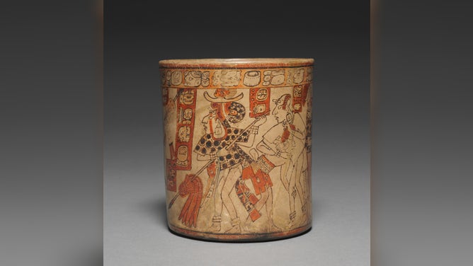 A Mayan vessel used for drinking chocolate, dated 600-900 a.d. The vessel depicts a lord, warriors and prisoners in the aftermath of battle.