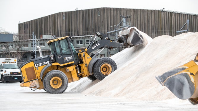 An excavator piles road salt in preparation for Winter Storm Kenan at the Boston Public Works Department yard on January 28, 2022 in Boston, Massachusetts.