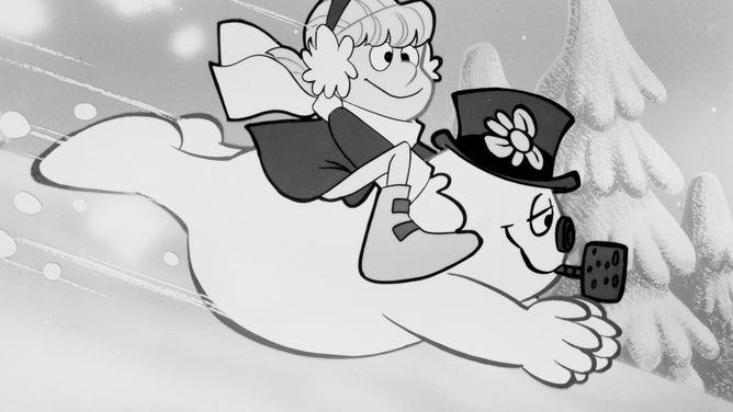 A still from the 1969 animated television special 'Frosty the Snowman', depicting Frosty sliding down a a snowy hillside with a child on his back.