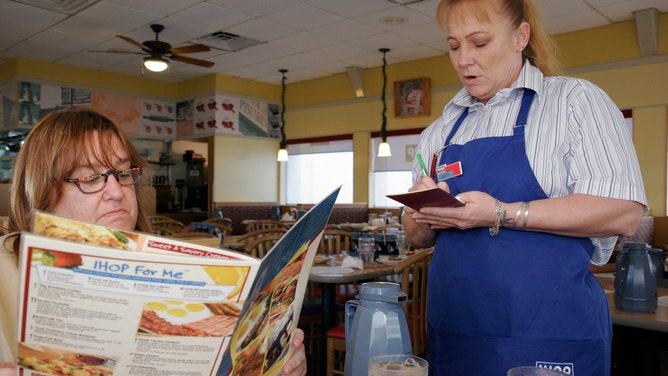 A waitress takes an order from a woman in Florida.