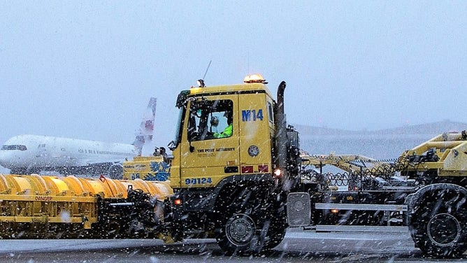 Snow falls on the tarmac at Newark Liberty International Airport on Jan. 7, 2022 in New Jersey.