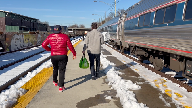A city of Lynchburg, Va. employee carries doughnuts to passengers on an Amtrak train that was stuck for more than 30 hours due to a snowstorm. (Image: City or Lynchburg)