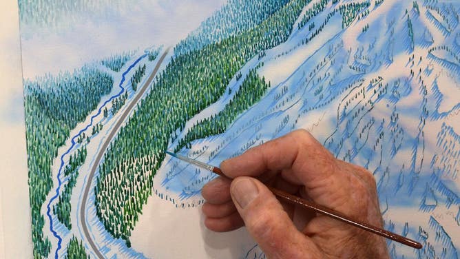 Niehues paints each tree on one of his maps.