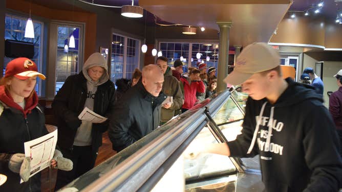 Visitors gaze at the many flavors offered at Moonlight Creamery during Ice Cream for Breakfast Day.