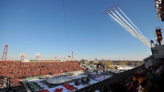 Canadian and American flags decorate the field as planes flyover the converted field. This was the 2011 NHL Heritage Classic Game at McMahon Stadium on February 20, 2011 in Calgary, Alberta, Canada.