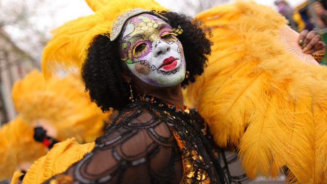A reveler dances down St. Charles Avenue during Mardi Gras celebrations in 2020.