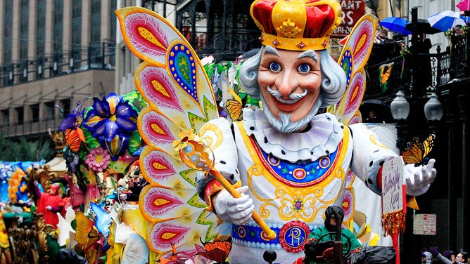 Members of Rex parade down St. Charles Avenue despite the rain during 2014 Mardi Gras Day.