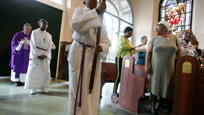 Worshipers attend an Ash Wednesday service at St. Jude's Church the day after Mardi Gras festivities in New Orleans.