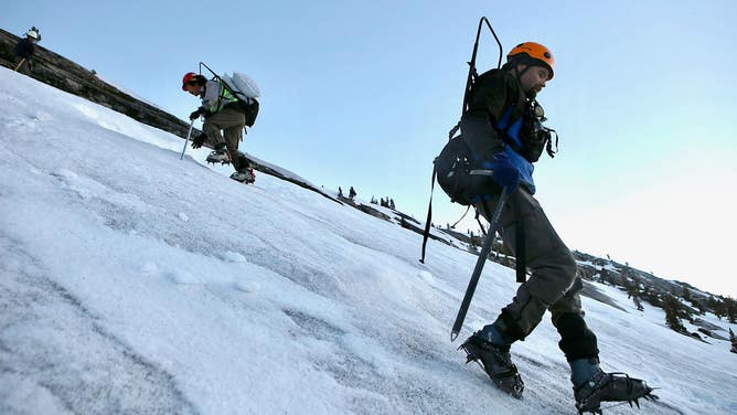 A Yosemite National Park avalanche team plants explosives in a severe avalanche area.