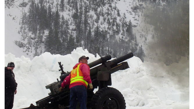 An avalanche control crew fires at the Liberty Bell Mountain avalanche chutes in Washington. May 4, 2010.