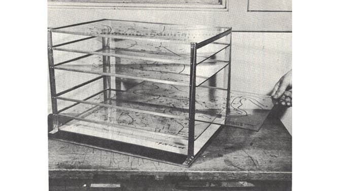 This three-dimensional model weather map device was designed at Tinker Air Force Base and included weather maps that were drawn on glass plates. The device allowed forecasters in 1949 to visualize weather patterns in three dimensions over a relatively large area. This type of device was first coined in 1935 by I. I. Zellon, a United States Bureau meteorologist in Pittsburgh.