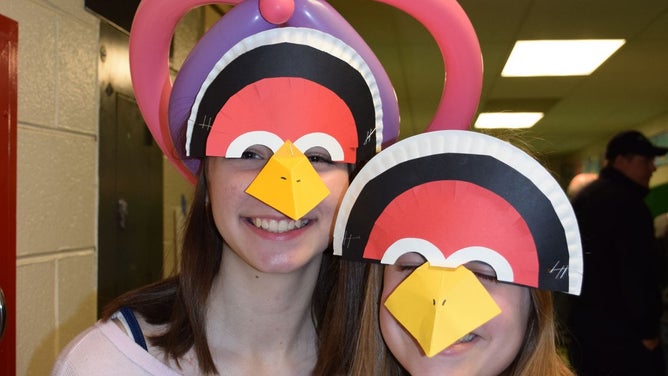 Buzzard Day celebrants wear buzzard masks.