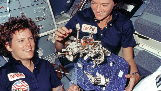 In this image taken on Oct. 13, 1984 aboard Space Shuttle Challenger on mission STS-41G, astronauts Kathryn D. Sullivan, left, and Sally K. Ride show off what appears to be a "bag of worms." STS-41G was the first flight to include two women. Sullivan became the first American woman to walk in space during the STS-41G mission and is a veteran of three shuttle missions.