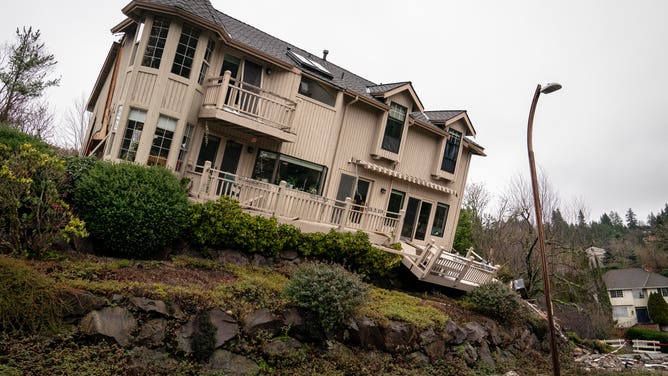 BELLEVUE, WA - JANUARY 20: A home sits at the bottom of a hill after sliding off its foundation in a recent landslide on January 20, 2022 in Bellevue, Washington. No injuries were reported as authorities investigate the cause of the landslide, after evacuating dozens of nearby residents from 15 homes. (Photo by David Ryder/Getty Images)