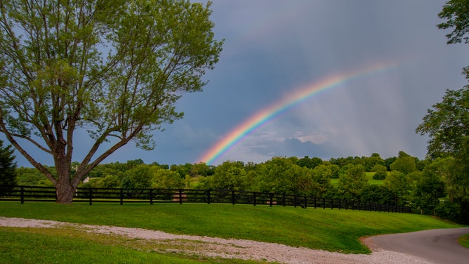 FILE - Colorful arc of a rainbow during a summer storm.