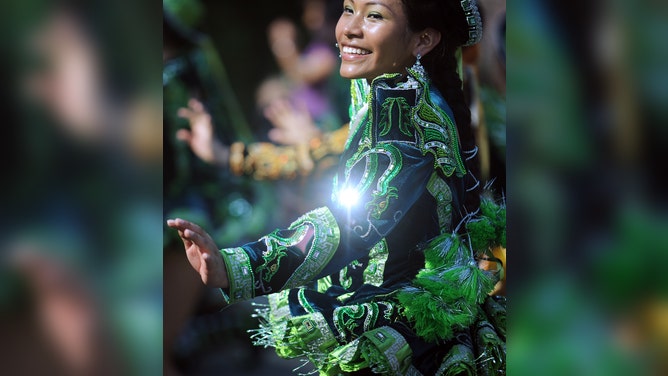 A woman dances with her Bolivian dance group while participating in the 12th annual St. Patrick's Day Parade in Gaithersburg, MD.