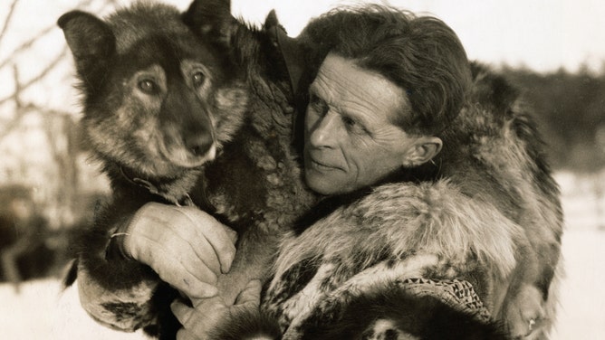Musher Leonhard Seppala holds Togo, the lead dog of his sled dog team during the Great Race of Mercy. According to the National Park Service, Togo led his team over 261 miles during the first and main drag of the race.