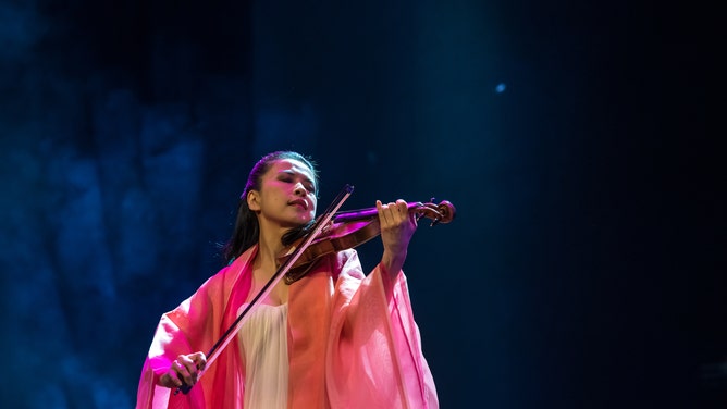 A violinist performs during one of the National Cherry Blossom Festival events.