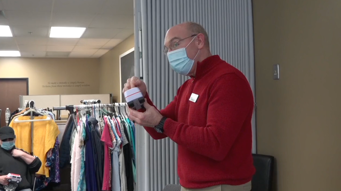 An instructor teaches a CPR class about cardiac compressions.