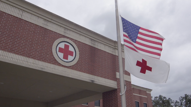 The American and Red Cross flags fly at an American Red Cross center.