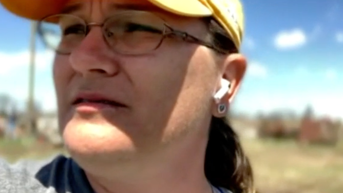 Volek stands amid the ruins of her neighborhood in Granger, TX.