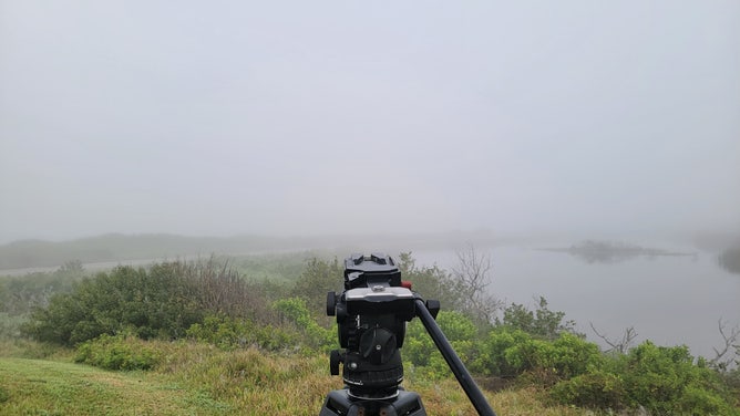 Thick fog covers the Launch Complex 39B at Kennedy Space Center where the SLS and Orion are standing on the pad.