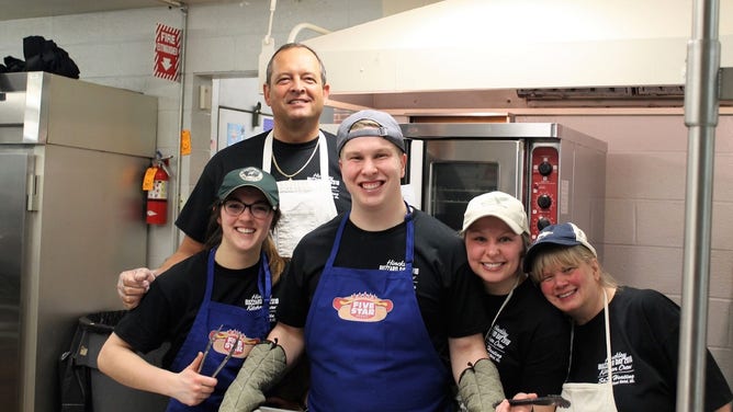 Dale Chorba, a.k.a. the Sausage King, stands tall behind his team. He has prepared the famous Buzzard Day-exclusive sausage for more than two decades with his dependable crew.