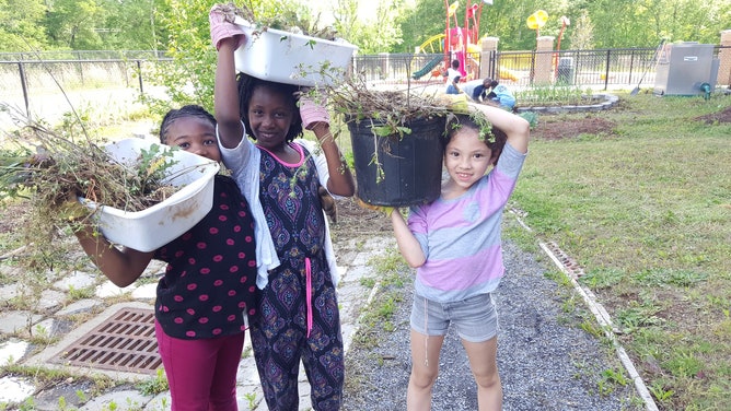 Three girls participate in Captain Planet Foundation's Project Learning Garden.