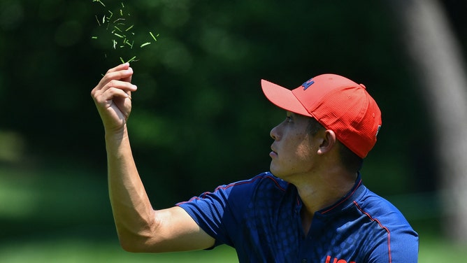 USA's Collin Morikawa checks the wind direction during the Tokyo 2020 Olympic Games at the Kasumigaseki Country Club in Kawagoe on August 1, 2021.