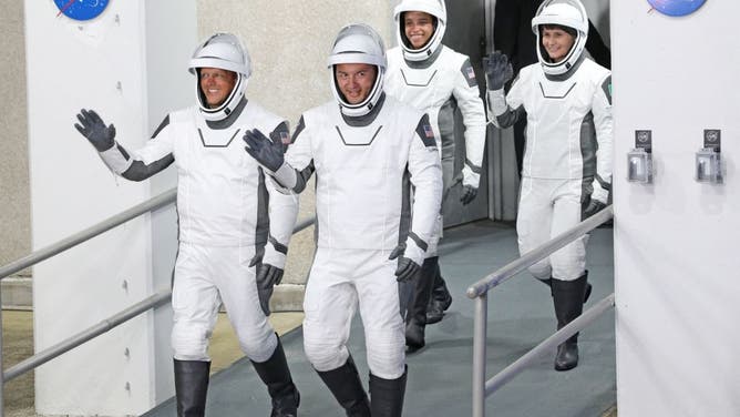 Crew-4 mission astronauts (from L) Bob Hines, Kjell Lindgren, Jessica Watkins and Samantha Cristoforetti of the European Space Agency walk out of the Neil A. Armstrong Operations and Checkout Building en route to launch complex 39A at the Kennedy Space Center in Florida on April 27, 2022. - The rocket will ferry the Crew Dragon spacecraft with NASA astronauts to the International Space Station. Their flight is the fourth crewed operational mission of a Crew Dragon spacecraft and the seventh overall crewed orbital flight since the United States resumed crewed space flight in May of 2020. (Photo by Gregg Newton / AFP) (Photo by GREGG NEWTON/AFP via Getty Images)