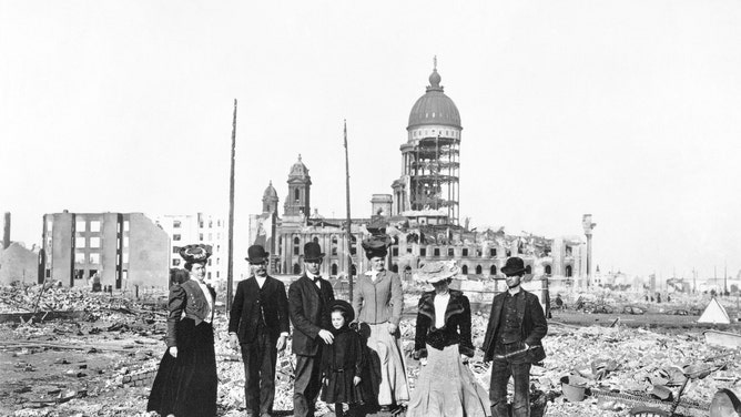 A small group of San Franciscans stand in front of what remained of City Hall. While much of the building crumbled away, its steel frame stood firm.
