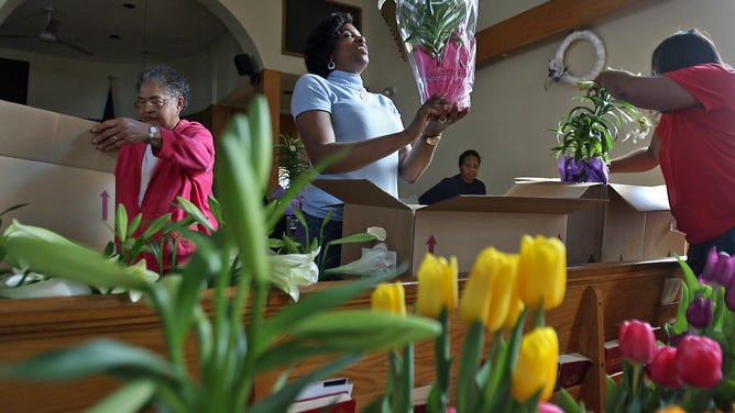 Parishioners at the 12th Baptist Church in Boston prepare flowers for Easter Sunday service.