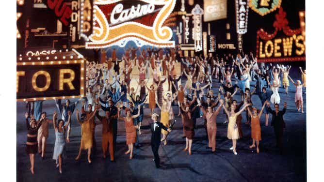 Gene Kelly sings with an army of fast steppers in a scene from the film "Singin' In The Rain". Scenes like these, with so many rich colors, enticed audiences back into the theater.