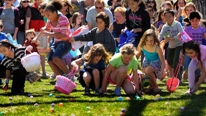 Children rush to pick up Easter eggs provided by the New Denver church.