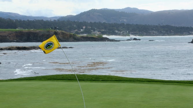 The flagstick on the 18th hole bends in the wind during a weather delay during the third round of the AT&amp;T Pebble Beach National Pro-Am at the Pebble Beach Golf Links on February 8, 2014 in Pebble Beach, California.