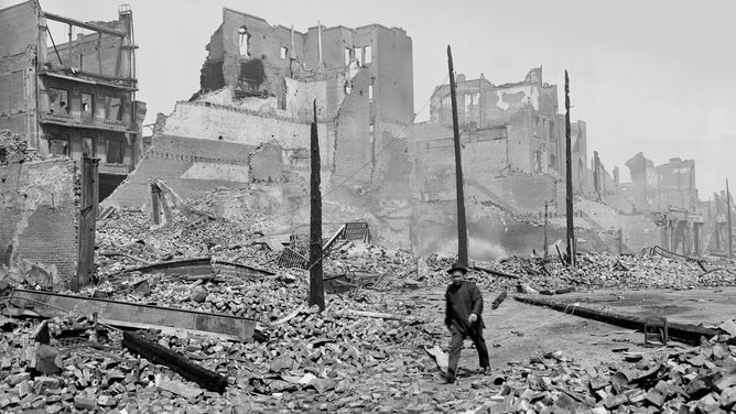 A man walks through the ruins of San Francisco's Chinatown after the 1906 earthquake.