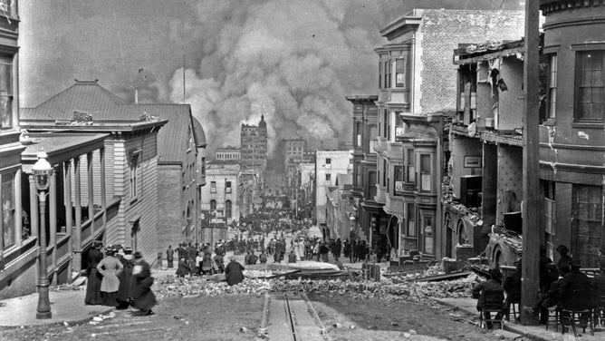 After the earthquake, large clouds of smoke billow in the background as San Franciscans watch the fires approach.