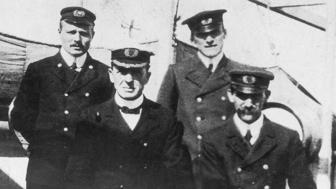 Captain Stanley Lord of the SS Californian (front row holding spy glass) poses with three senior officers.