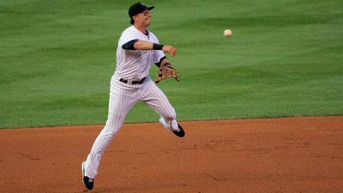 Shortstop Troy Tulowitzki #2 of the Colorado Rockies throws out a runner at Coors Field on July 24, 2009 in Denver, Colorado.