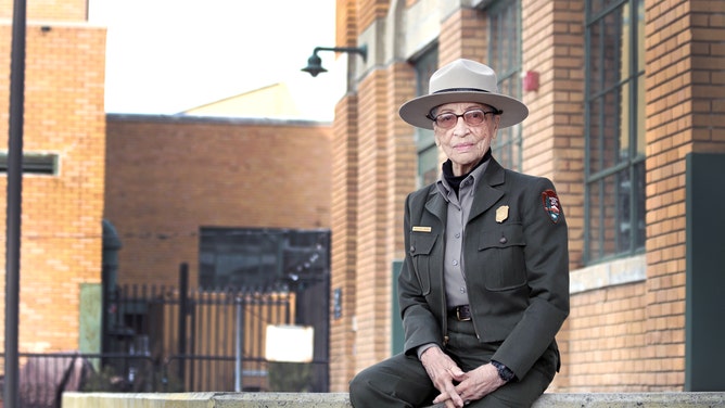 Ranger Betty Reid Soskin sits in front of the Rosie the Riveter Visitor Center. (Image: NPS Photo/Luther Bailey)