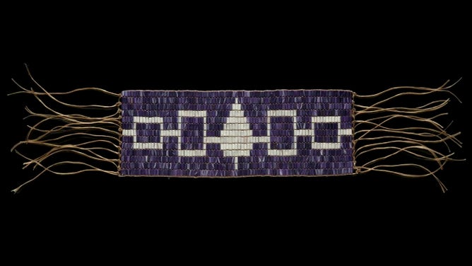 Replica of the Hiawatha wampum belt. The Belt symbolizes the unity of the original five Haudenosaunee nations, which are each represented by white squares and a tree.