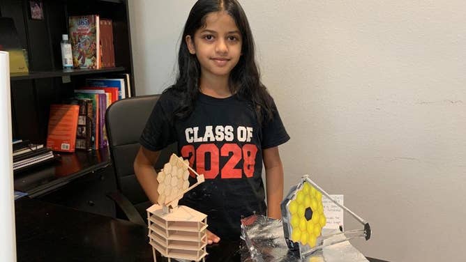 Pranavi Chatrathi poses with the two James Webb Space Telescope models she built for the Texas State Fair.
