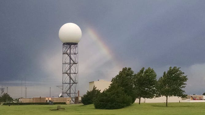A rainbow beams next to the radome at NEXRAD ROC in Norman, Oklahoma.