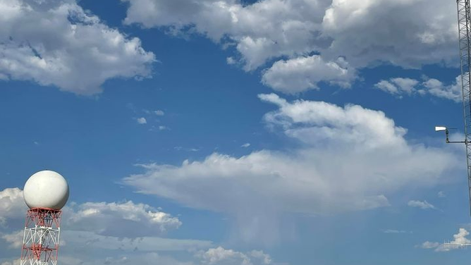 Radar with cloudy skies in the background at NWS San Angelo, Texas.