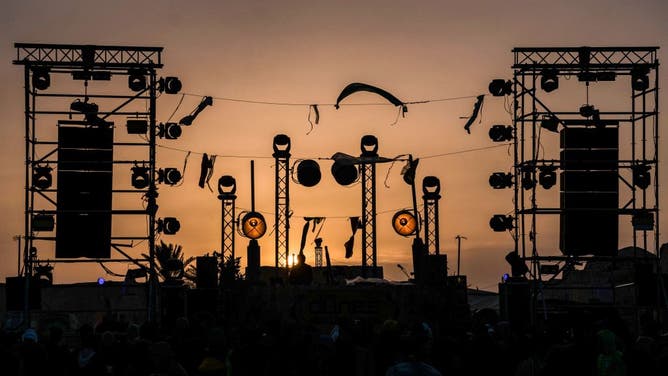 People dance at the electronic music festival "Les Dunes Electroniques" at Ong Jmel, near the town of Nefta in western Tunisia on November 16, 2019, where the original Star Wars film was shot.(Photo by AMINE LANDOULSI / AFP) (Photo by AMINE LANDOULSI/AFP via Getty Images)