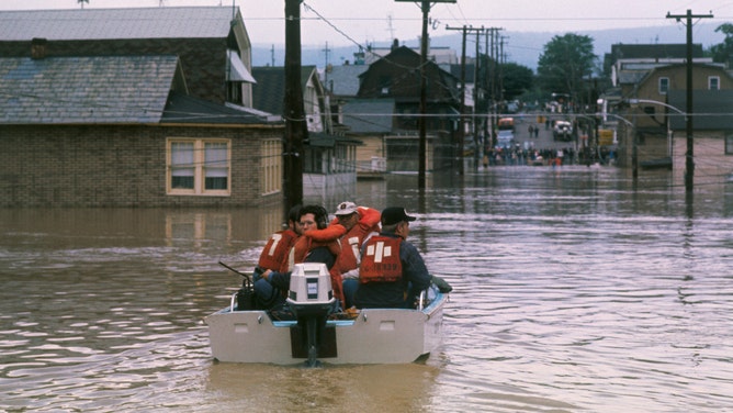 Rescue workers in a motorboat ride through a flooded Wilkes-Barre, Pennsylvania, street on June 24, 1972, searching for people stranded in homes. More than 100,000 people in the Wilkes-Barre area had to be evacuated as a result of flooding caused by the remnants of Hurricane Agnes. Wilkes-Barre was flooded when the Susquehanna River crested at 43 feet, more than 20 feet above the flood stage. Referring to the situation throughout the state, Governor Milton Shapp said, "Without a doubt, this is the worst disaster in the history of Pennsylvania."