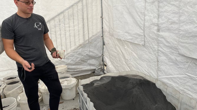 Exolith Lab operations manager Konrad Krol shows how materials are ground down to make lunar and Mars regolith. (Image: Emilee Speck/FOX Weather)