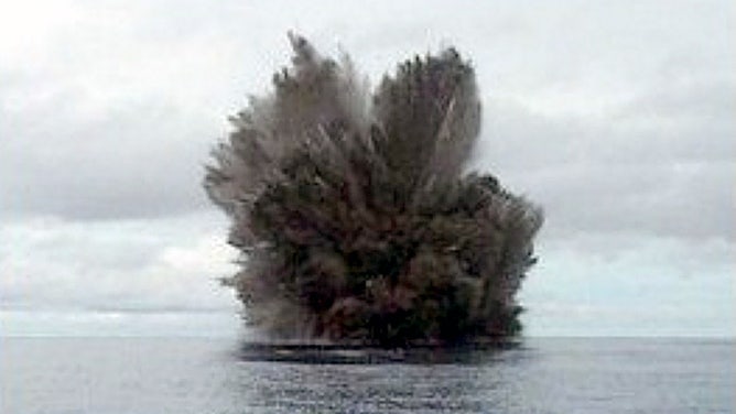 A cock’s-tail plume rises above Kavachi volcano during a Surtseyan eruption on 15 March 2004. Projections of individual blocks and ash can be seen at the margins of the plume. (Image: Corey Howell/ Smithsonian Institute Global Volcanism Program)